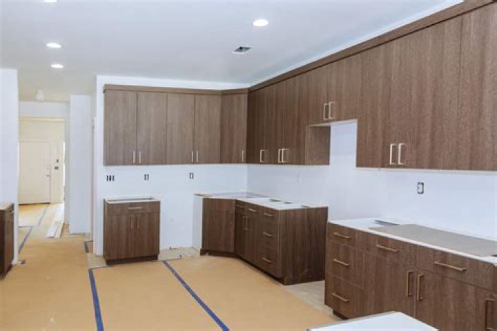 Do you put flooring under kitchen cabinets?