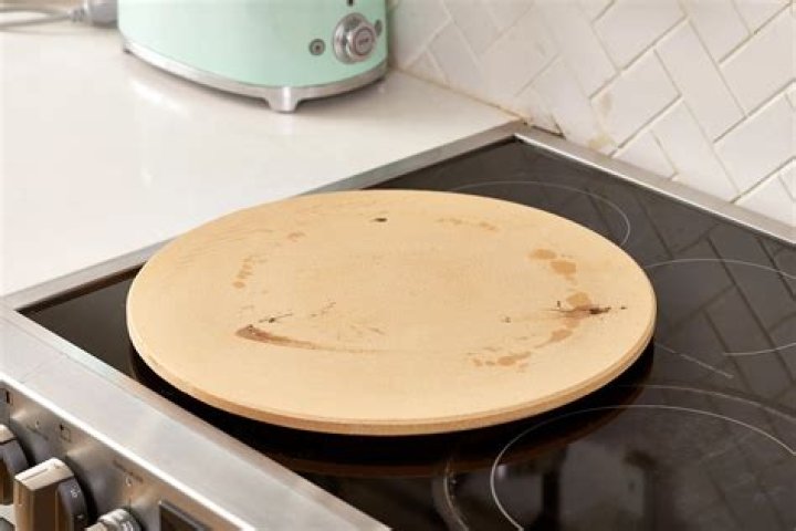 How do you transfer pizza to a pizza stone?