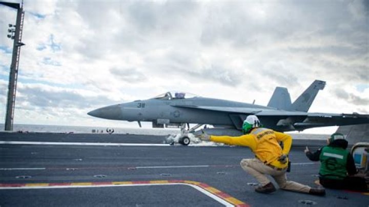 Why do Navy pilots salute before takeoff?