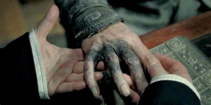 Why is Dumbledore's hand Black?